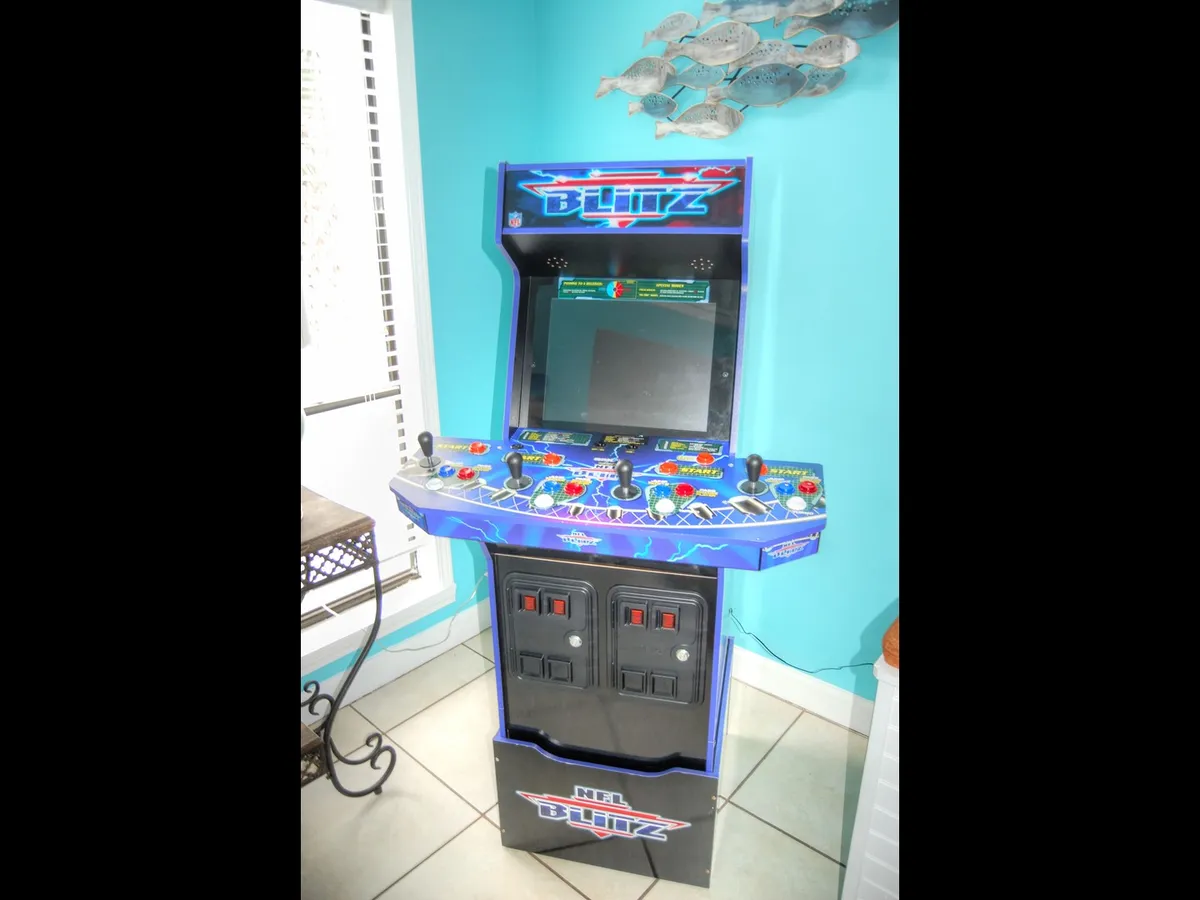 An interior scene featuring a classic arcade machine, evoking nostalgia and offering in-home entertainment. The space is designed for friendly competitions and playful socializing among adult travelers, providing a unique alternative to going out.